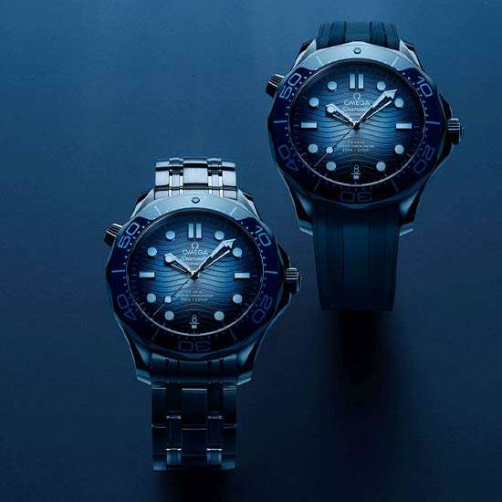 The Omega Seamaster 42 mm model is crafted from stainless steel and includes a blue ceramic bezel with a white enamel diving scale. 